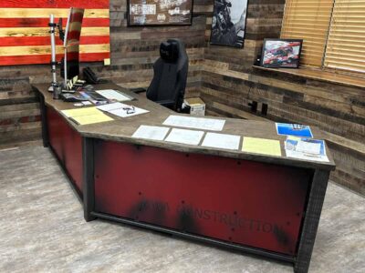 Custom industrial reception desk - dark stained white oak with weathered red privacy panels and welded raw exposed steel base