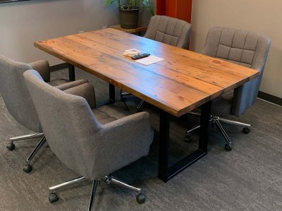 natural unstained reclaimed pine office meeting table with plush gray fabric office rolling chairs